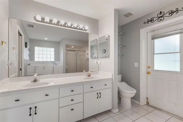 a view of an empty room with a window and kitchen view