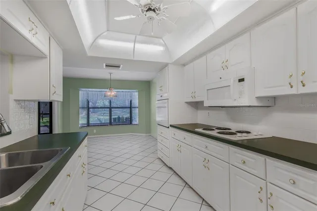 a kitchen with granite countertop a sink stainless steel appliances and cabinets