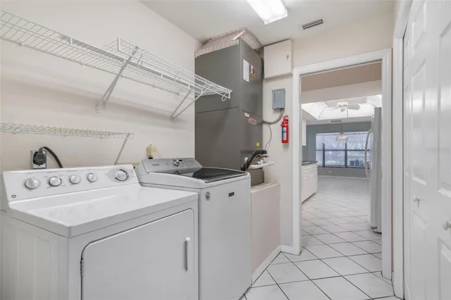 an aerial view of a house with a yard and a large tree