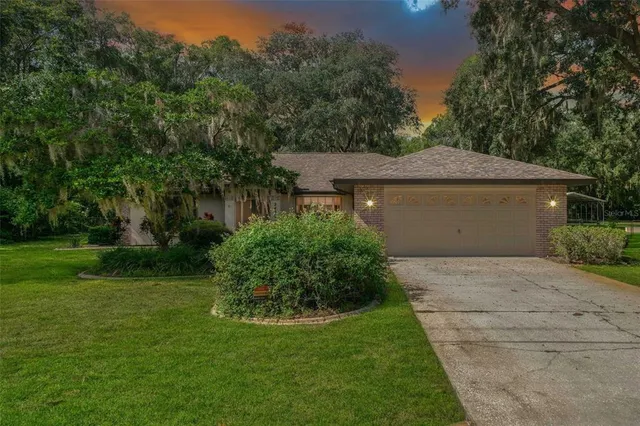 a sign board with grassy field