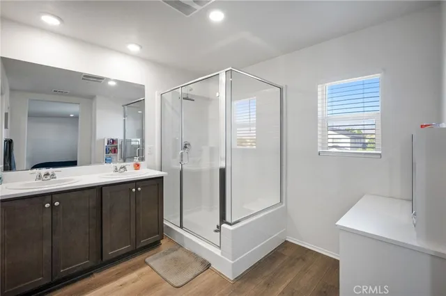 a bathroom with a shower sink and mirror