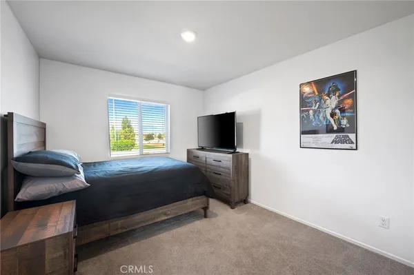a bedroom with a bed and a television