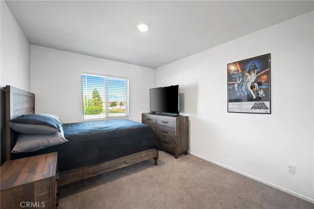 a bedroom with a bed and a television