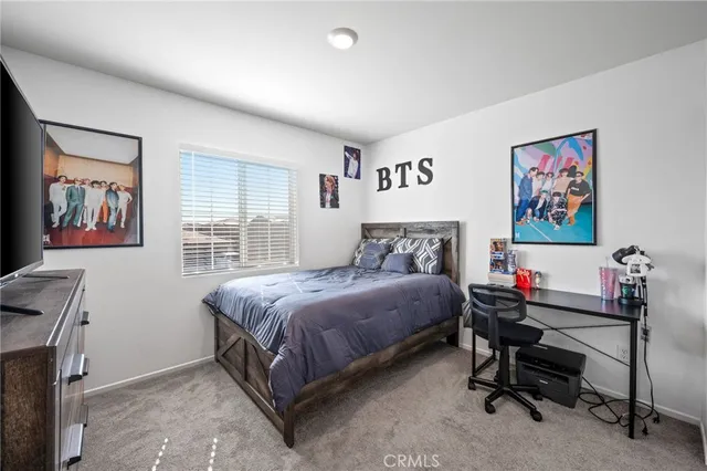 a bedroom with a bed and a desk