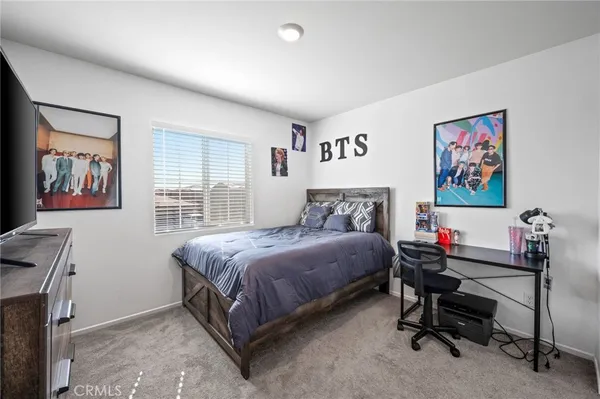 a bedroom with a bed and a desk