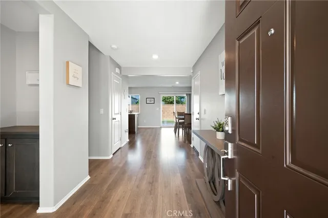 a view of a hallway with wooden floor fireplace and living room
