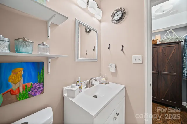 a bathroom with a sink vanity and mirror