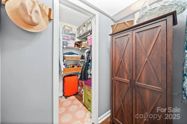 a work room with furniture a flat screen tv and a window