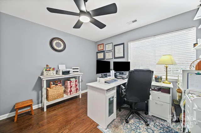 a view of a workspace with furniture and a window
