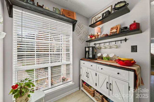 a kitchen with granite countertop a white stove top oven and cabinets