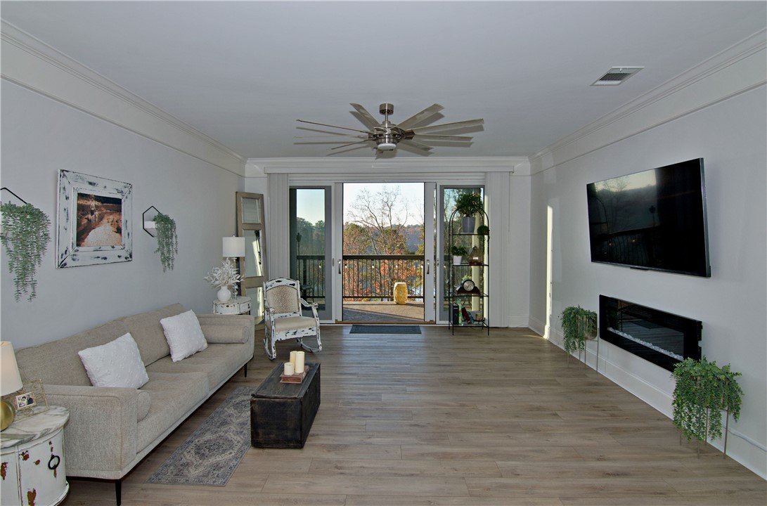 601 Watermarke Lane Anderson, SC 29625 - Photo 6 of 25 This living area features ample space and access to an outdoor balcony with scenic views.