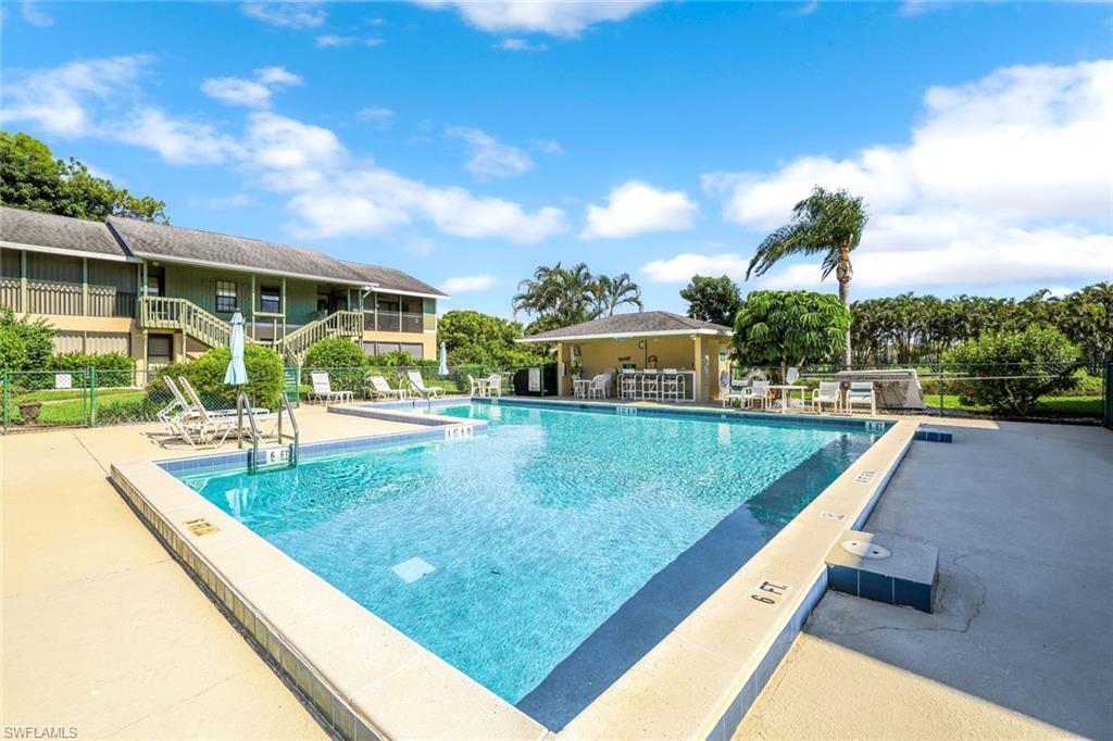 5501 Rattlesnake Hamm Road, Unit 109 Naples, FL 34113 - Photo 1 of 17 a view of a swimming pool with a patio