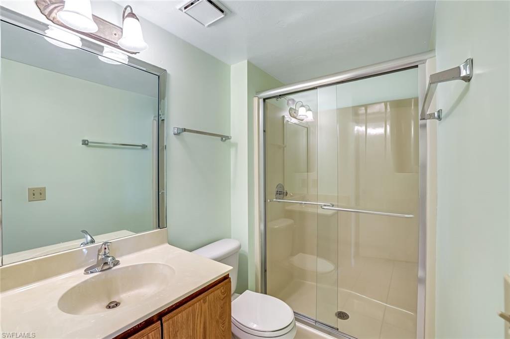 5501 Rattlesnake Hamm Road, Unit 109 Naples, FL 34113 - Photo 14 of 17 a bathroom with a sink toilet and shower
