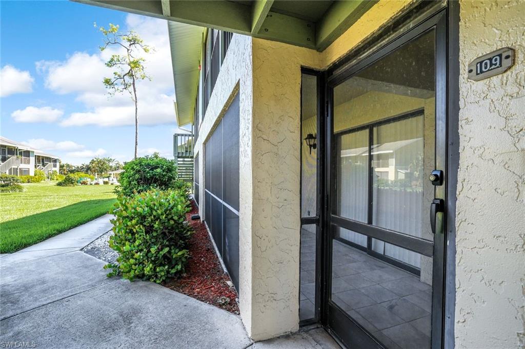 5501 Rattlesnake Hamm Road, Unit 109 Naples, FL 34113 - Photo 16 of 17 a view of a potted plants from a glass door