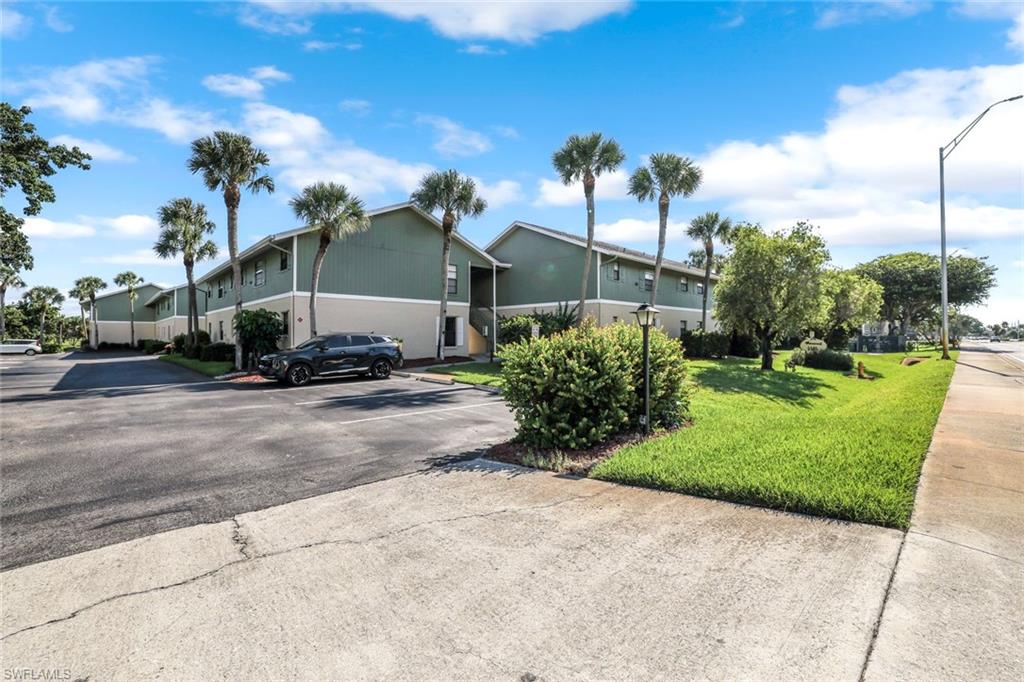 5501 Rattlesnake Hamm Road, Unit 109 Naples, FL 34113 - Photo 17 of 17 a view of a street with a building in the background