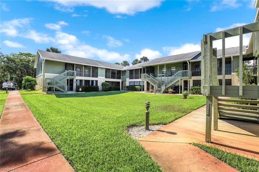 5501 Rattlesnake Hamm Road, Unit 109 Naples, FL 34113 - Photo 4 of 17 a house view with a garden space