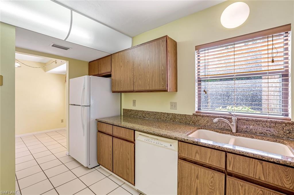 5501 Rattlesnake Hamm Road, Unit 109 Naples, FL 34113 - Photo 8 of 17 a kitchen with a sink cabinets and window