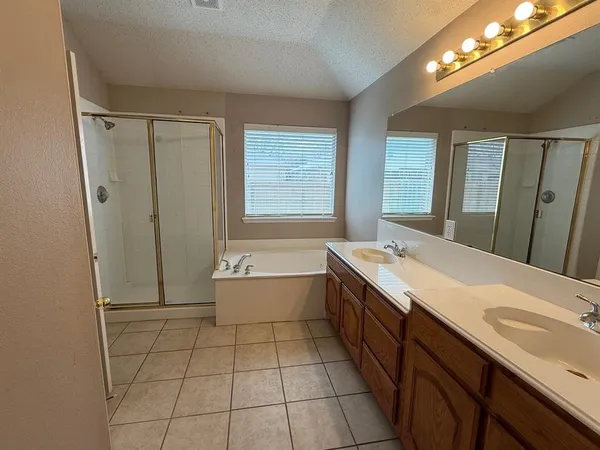 a bathroom with a granite countertop sink a toilet and bathtub
