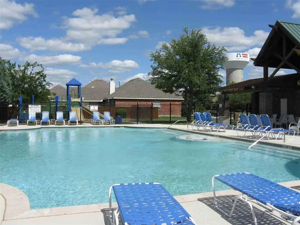 a front view of a house with swimming pool having outdoor seating