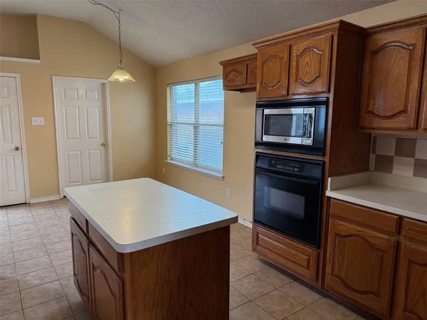 a kitchen with stainless steel appliances a stove microwave and cabinets