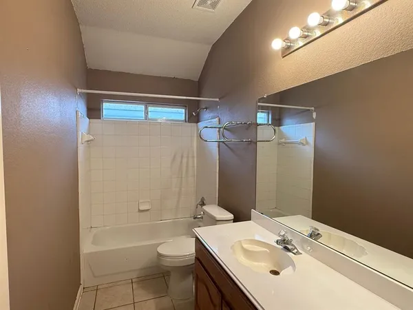 a bathroom with a sink toilet vanity and shower