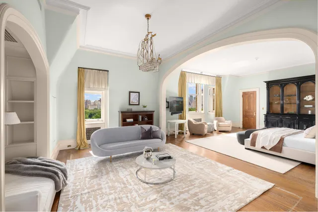 a spacious bedroom with a bed and glass window