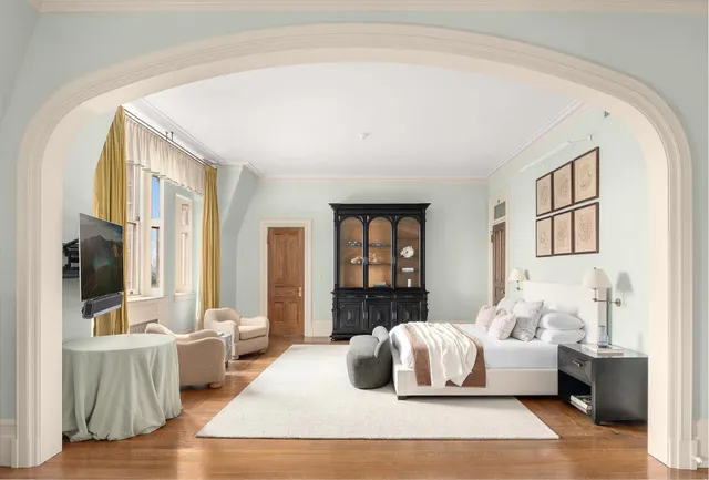 a living room with furniture chandelier and a table