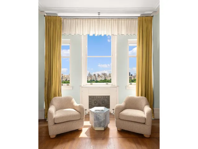 a bedroom with furniture and a large window