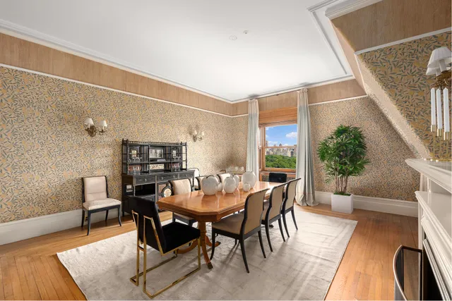 a dining room with furniture a fireplace and wooden floor