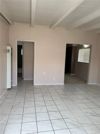 a view of a livingroom with an empty space and a window