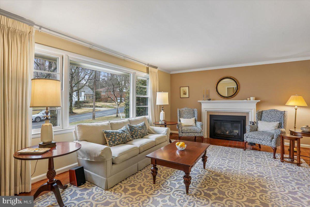 3612 Littledale Road Kensington, MD 20895 - Photo 14 of 79 a living room with furniture a fireplace and a floor to ceiling window