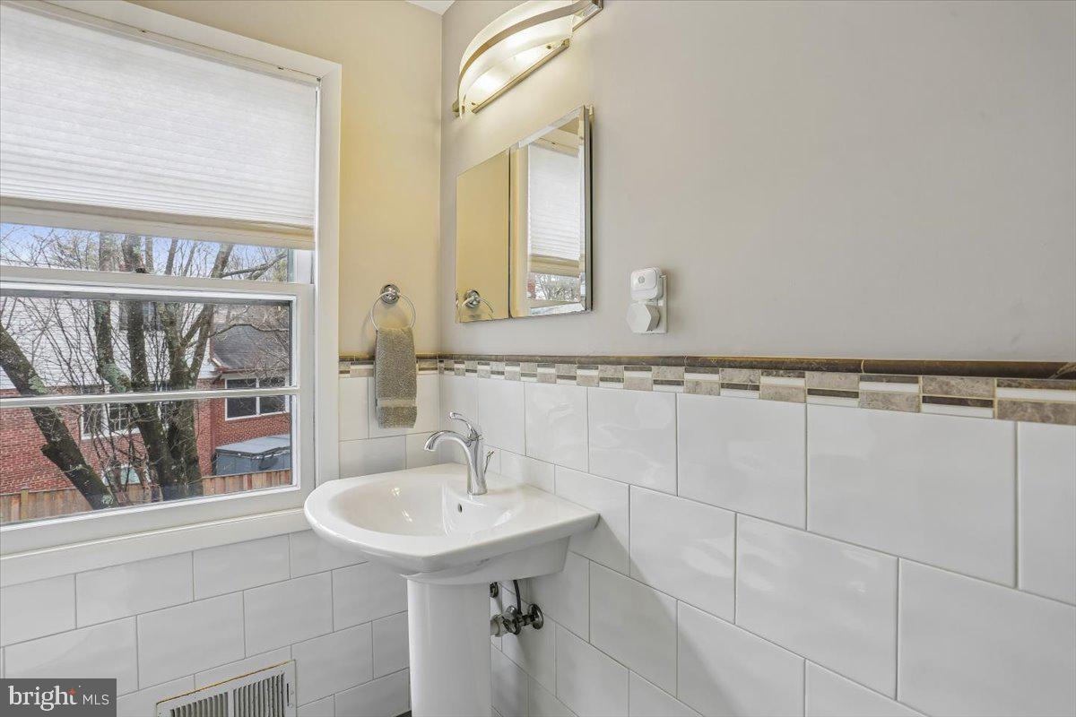 3612 Littledale Road Kensington, MD 20895 - Photo 42 of 79 a bathroom with a sink and a mirror