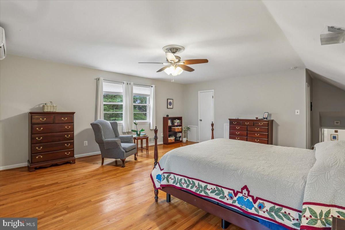 3612 Littledale Road Kensington, MD 20895 - Photo 47 of 79 a room with a bed and a bookshelf with wooden floor