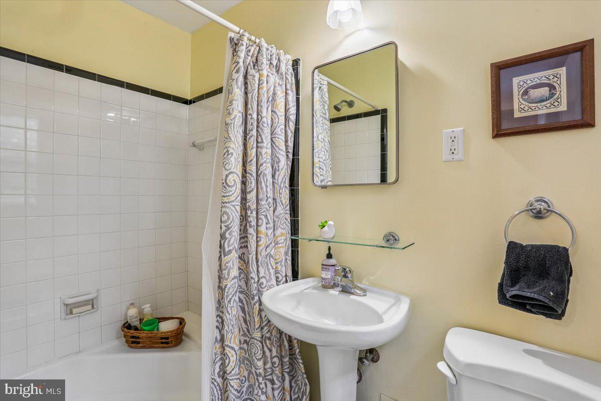 3612 Littledale Road Kensington, MD 20895 - Photo 59 of 79 a bathroom with a sink mirror and toilet