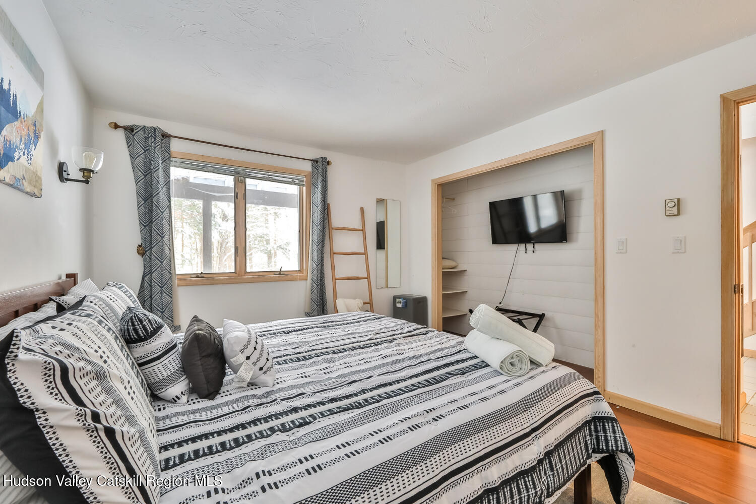 31 Koonan Road Windham, NY 12496 - Photo 14 of 48 a bedroom with a bed and a flat screen tv