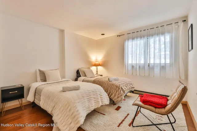 a living room with lots of furniture and a large window