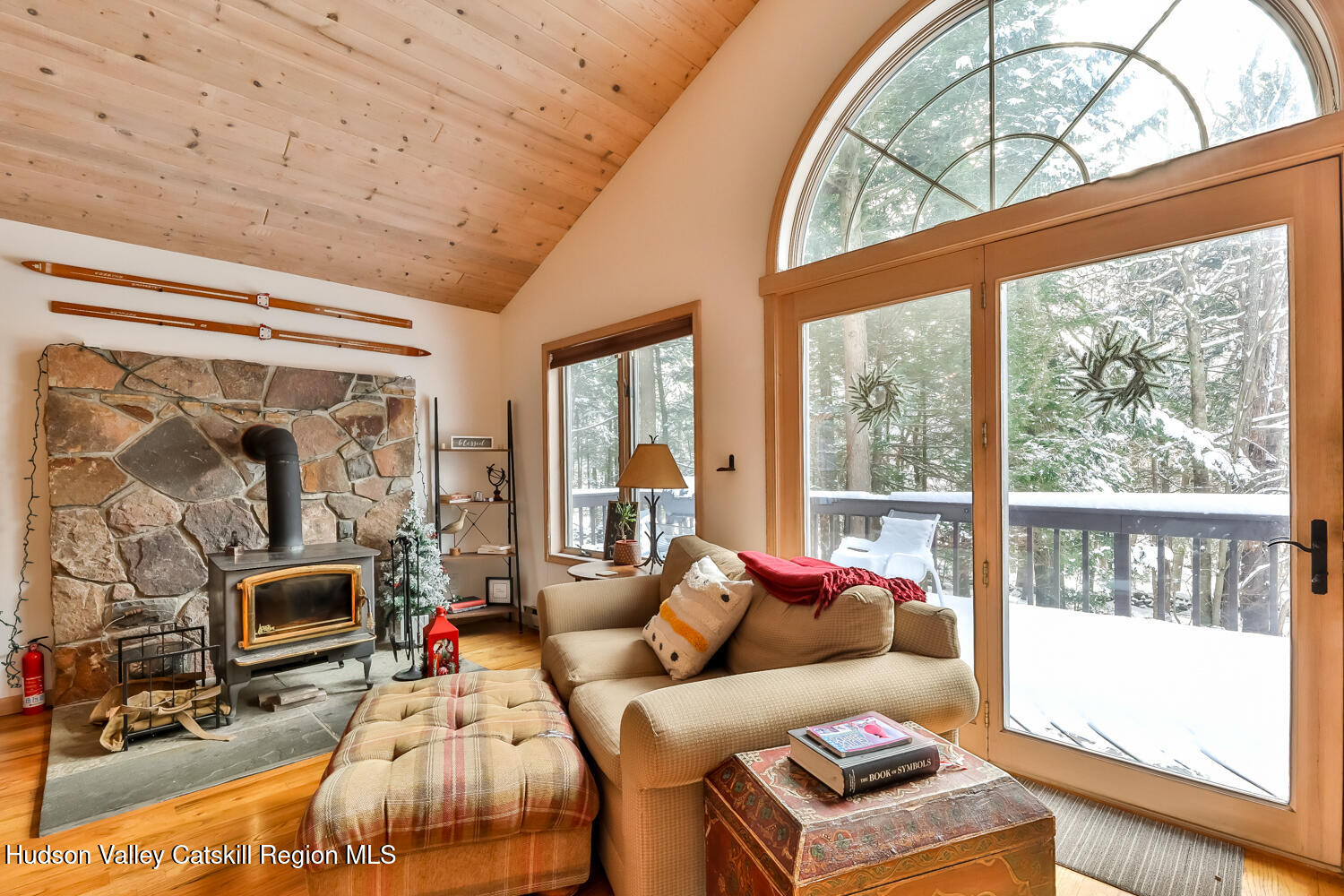 31 Koonan Road Windham, NY 12496 - Photo 25 of 48 a living room with furniture a flat screen tv and a floor to ceiling window