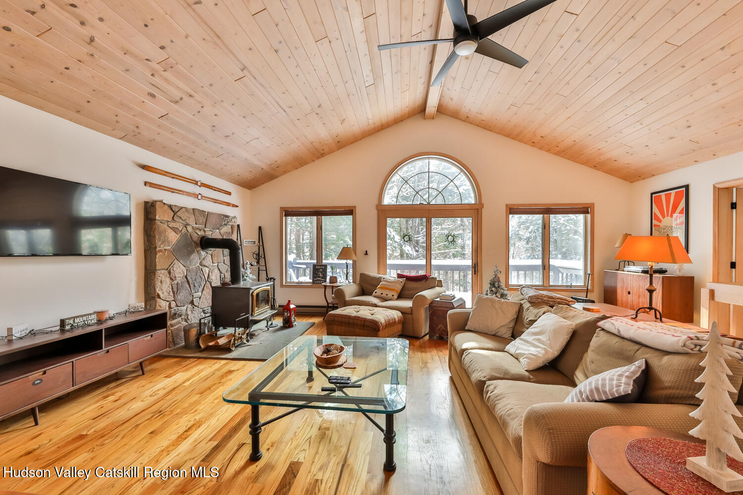 31 Koonan Road Windham, NY 12496 - Photo 26 of 48 a living room with furniture a flat screen tv and a large window