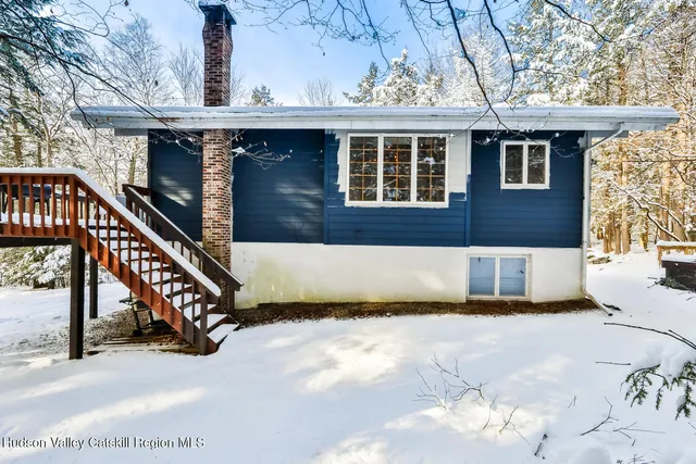 a bedroom with a bed and glass door