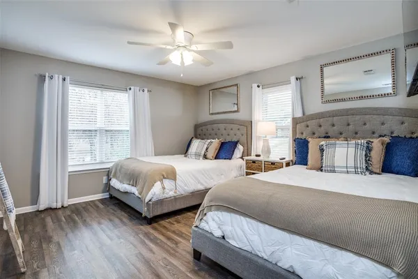 a bedroom with two beds and a large window