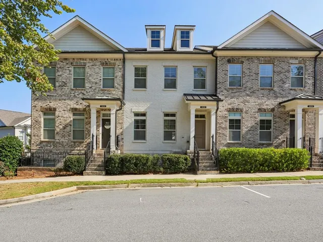 a front view of a house with a yard and a garage
