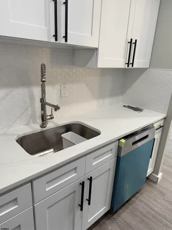 a view with granite countertop a sink and a stove