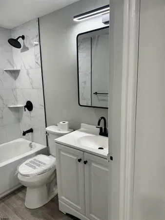 a bathroom with a sink toilet and shower