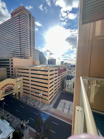 a view of a balcony with two chairs and a barbeque