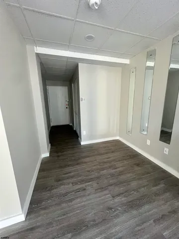 a view of a room with wooden floor and white doors