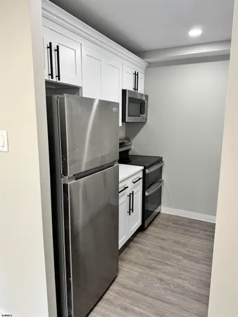 a kitchen with stainless steel appliances a refrigerator sink and microwave