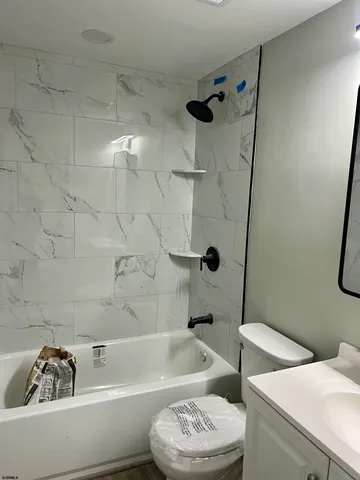 a bathroom with a bathtub a toilet and a shower