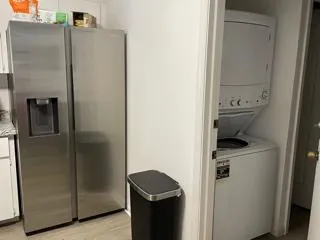 a living room with furniture and kitchen view