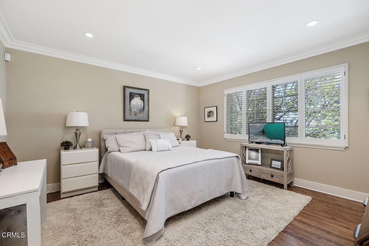 320 North San Rafael Avenue Pasadena, CA 91105 - Photo 31 of 58 a bedroom with a large bed and a wooden floor