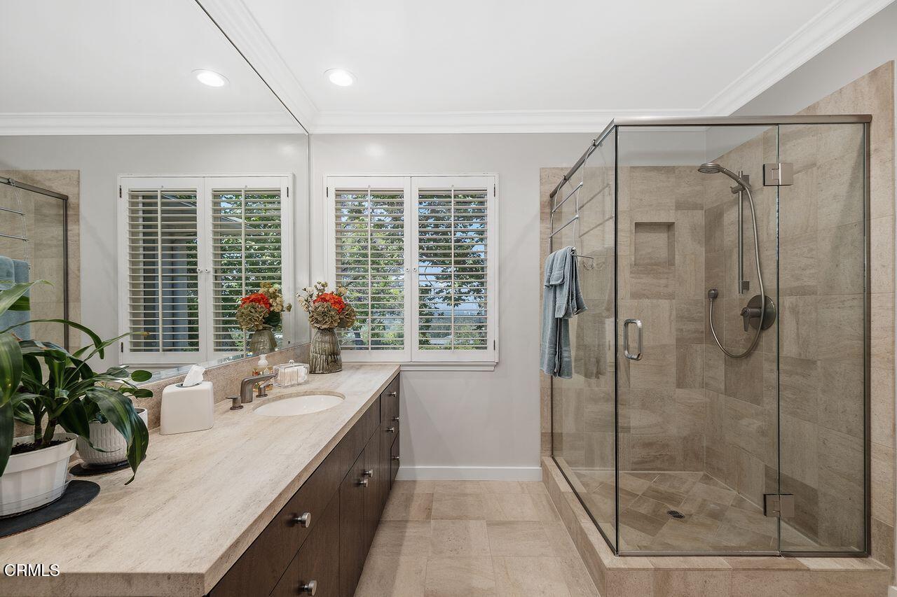 320 North San Rafael Avenue Pasadena, CA 91105 - Photo 32 of 58 a bathroom with a granite countertop sink a potted plant and a shower